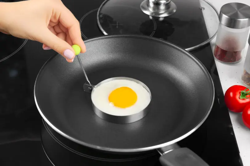 Woman Frying Sunny Side up Egg in Egg Ring